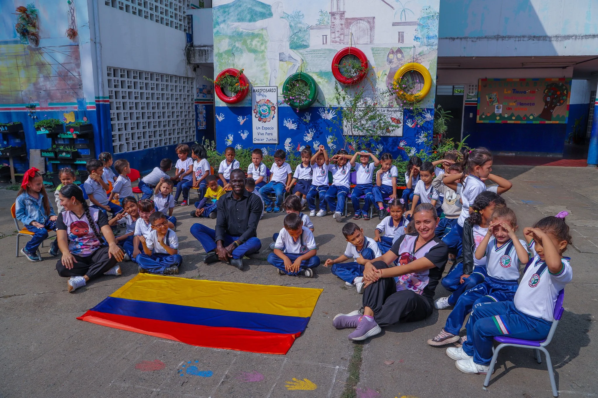  Scholar Aiita (in the centre of the photo) visiting a local primary school while attending COP16 in Colombia 