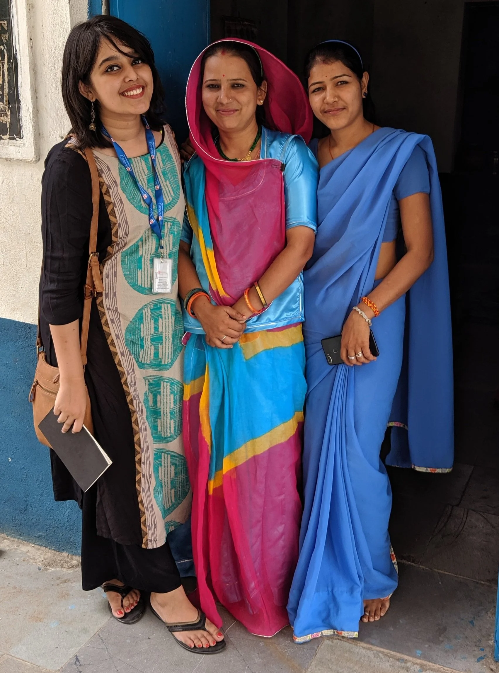Rai Sengupta during a field visit to Rajasthan, India, standing with front line health care workers who work to improve nutritional outcomes for women and children in their villages.