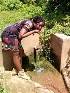 Drinking from a protected spring in my rural home in Kenya 